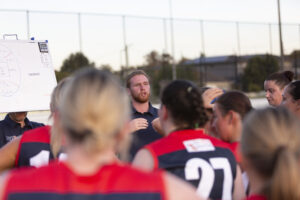 Demons lock in coach