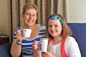 Abbie raises a cup for kids